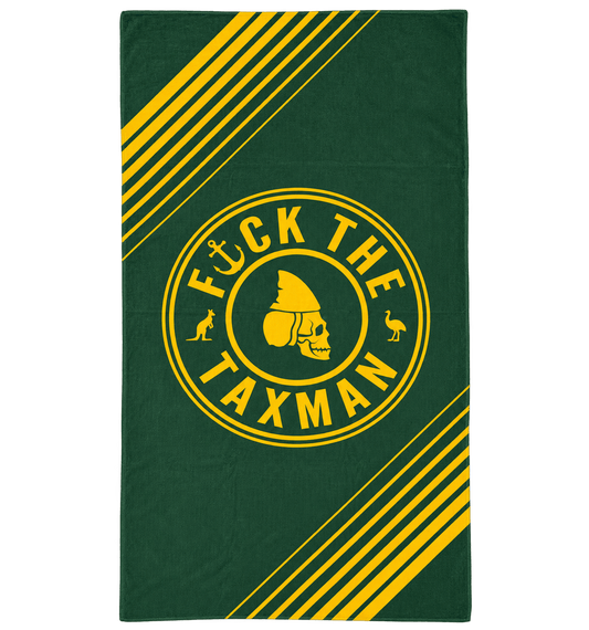A rectangular dark green towel featuring a bold yellow graphic with diagonal stripes and a central circular emblem containing a skull and the text 'F*CK THE TAXMAN'.